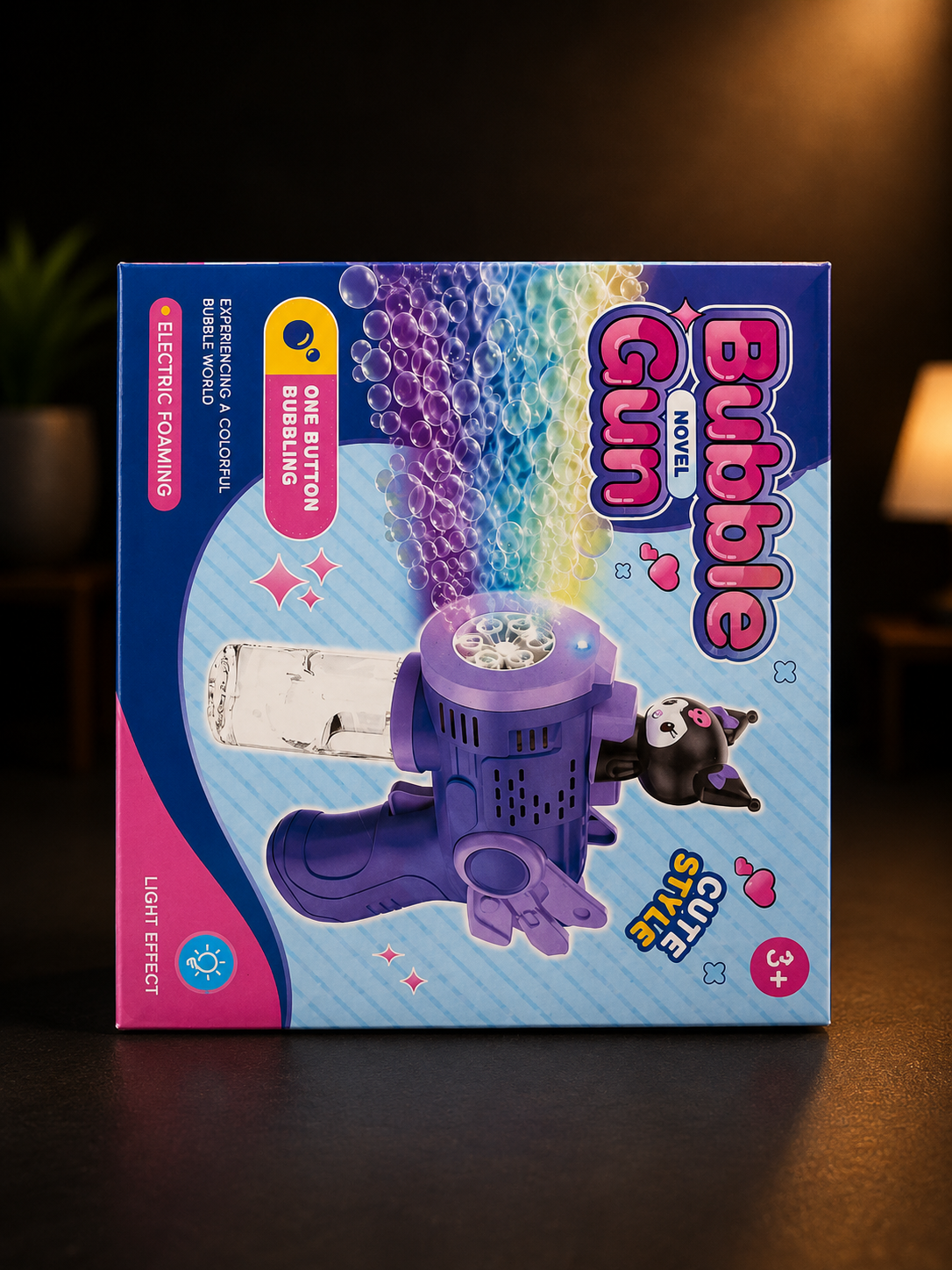 Box of a bubble gun with colorful design on a dark background

